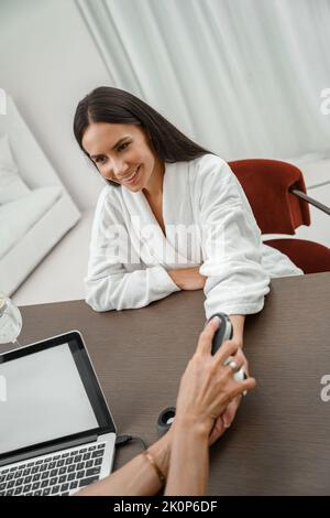 Woman in white bathrobe on medical examination before procedures in spa salon Stock Photo