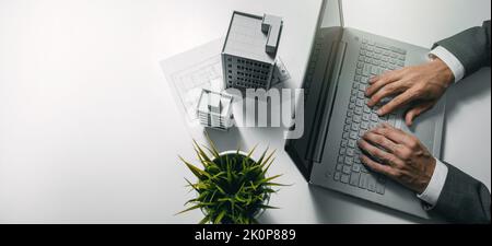 real estate business and development. businessman using laptop and working on housing project in office. banner with copy space Stock Photo