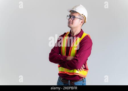 Portrait of serious young foreman with hard hat in a studio. Architect, Engineer, Civil Concept of Construction. Stock Photo