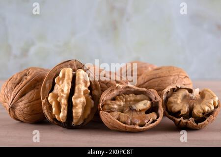 Cracked and whole walnuts together Stock Photo