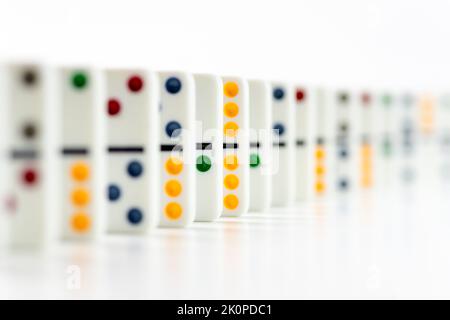 Dominoes. Dominos pieces with colorful dots in row on white background Stock Photo