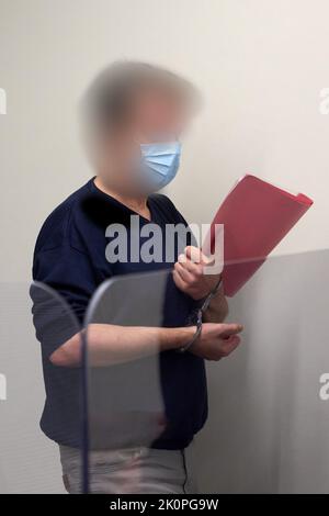 Bad Kreuznach, Germany. 13th Sep, 2022. The defendant enters the courtroom in handcuffs. In the trial of the fatal shooting of a gas station employee in a dispute over the Corona mask requirement, the defendant has been sentenced to life imprisonment. Credit: Thomas Frey/dpa/Alamy Live News Stock Photo