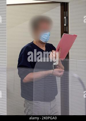 Bad Kreuznach, Germany. 13th Sep, 2022. The defendant enters the courtroom in handcuffs. In the trial of the fatal shooting of a gas station employee in a dispute over the Corona mask requirement, the defendant has been sentenced to life imprisonment. Credit: Thomas Frey/dpa/Alamy Live News Stock Photo