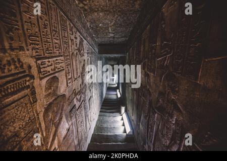 View to an Ancient Egyptian Drawing on the Walls of the Dendera Temple complex in south-east of Dendera, Egypt Stock Photo