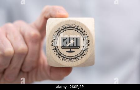Hand holding a wooden cube with symbol of software update concept Stock Photo