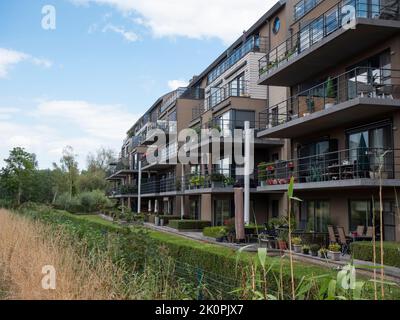 Lokeren, Belgium, August 27, 2022, apartment building with balconies overlooking the river Durme and beautiful nature Stock Photo