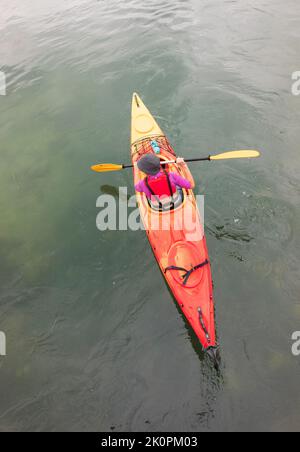Middle-aged person kayaking on the lake Stock Photo