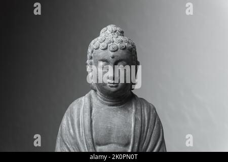 Siddharha Gautama Buddha statue made of grey stone as interior decoration Stock Photo