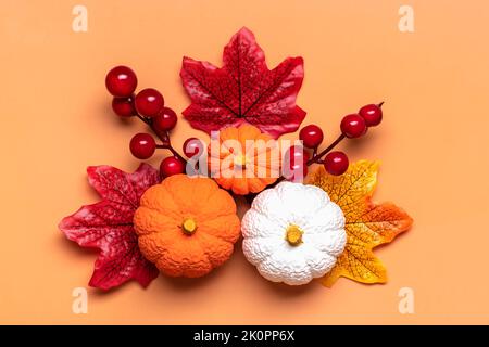Autumn floral composition with orange pumpkins. Wreath of dry maple, oak  leaves, flowers, acorns, fig and apple fruit. White table background. Fall,  H Stock Photo - Alamy