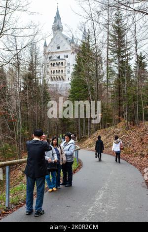 Hohenschwangau, Germany - April 28, 2013: Tourists from China taking photo by Neuschwanstein Castle in the Bavarian Alps Stock Photo