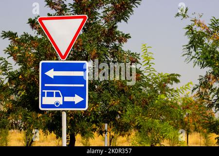 Road direction bus lane sign blue background Stock Photo