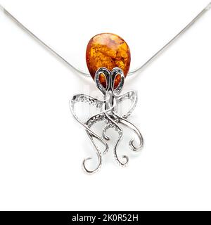 Amber jewellery set in a variety of different fittings from Octopus to bees. 925 silver.  Shot on white backgrounds. Stock Photo