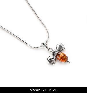 Amber jewellery set in a variety of different fittings from Octopus to bees. 925 silver.  Shot on white backgrounds. Stock Photo