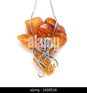 Amber jewellery set in a variety of different fittings from Octopus to bees. 925 silver.  Shot on white backgrounds. Stock Photo