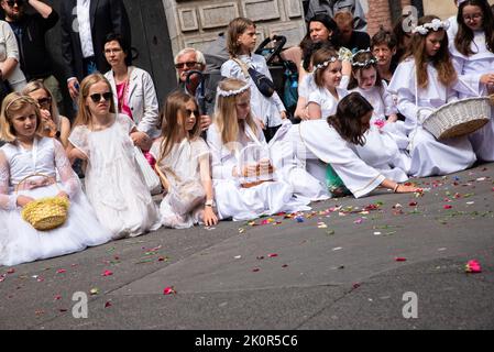 Kids seen dressed in white dresses during the procession. Corpus Christi - liturgical celebration in the Catholic Church in honor of Jesus Christ in the Blessed Sacrament. A procession of believers passed through the streets of Gda?sk. Stock Photo