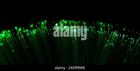 Fiber optic filaments glowing green. Wide format with black background Stock Photo