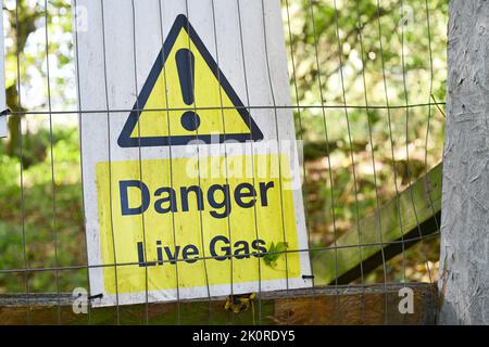 warning sign of live gas on construction site united kingdom Stock Photo