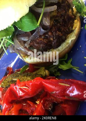 Gourmet Burger on Blue Plate with Roasted Peppers Stock Photo