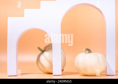 Podium or pedestal with pumpkins for products display or advertising for autumn holidays. Trendy  pedestal and stand mock up composition with decorati Stock Photo