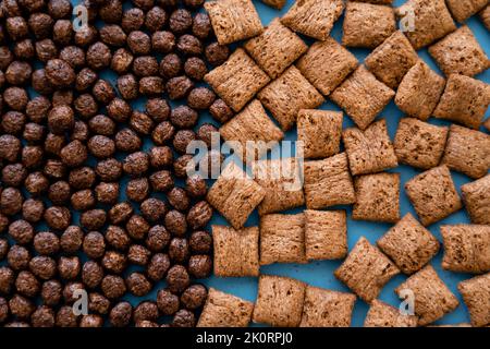 top view of tasty chocolate cereal balls and puffs on blue,stock image Stock Photo
