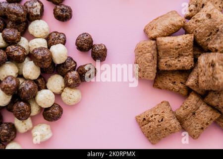 top view of various breakfast cereal puffs and balls isolated on pink,stock image Stock Photo