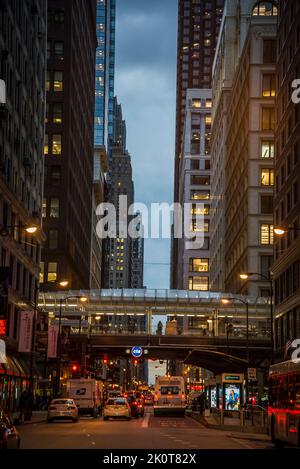 Street at nighttime and train passing over an  L-railway line bridge, Chicago, Illinois, USA Stock Photo