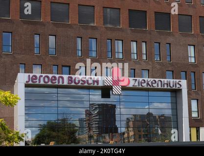Close-up of the main entrance of 'Jeroen Bosch'-hospital. Reflection in the glass shows residential buildings. Stock Photo