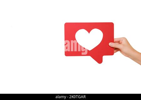Appreciate content with heart button. Closeup of woman hand holding like icon of social media, emoji sign to follow subscribe interesting blog, popula Stock Photo