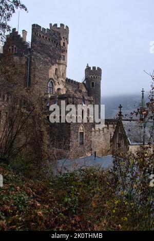 Trechtingshausen, Germany - December 20, 2020: Side of Rheinstein Castle above the Rhein river o a foggy fall day in Germany. Stock Photo