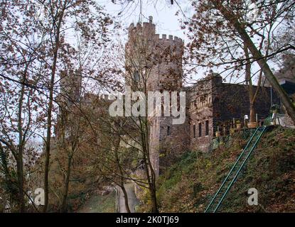 Trechtingshausen, Germany - December 20, 2020: Medieval Rheinstein castle on a cloudy fall day above the Rhein river in Germany. Stock Photo