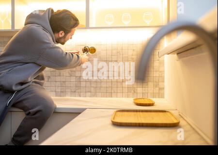 Professional installing an electrical outlet on the wall Stock Photo