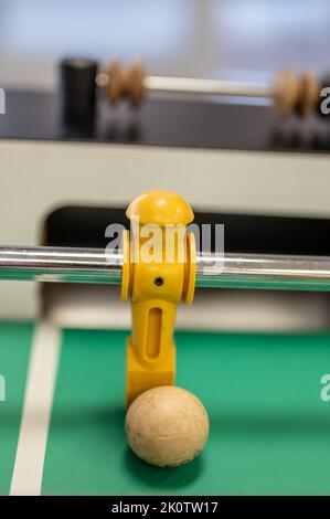 Selective focus on a foosball goalie blocking the ball insider the box. Stock Photo