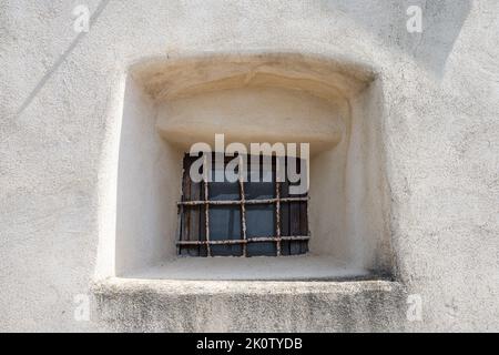 Small window set in an ancient wall. Stock Photo