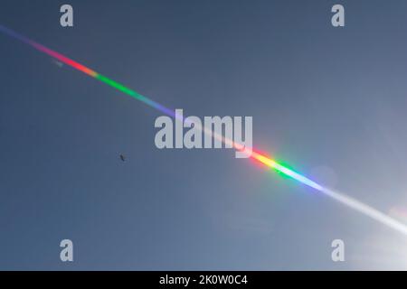 Rainbow flash as flare from the sun Stock Photo