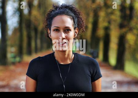 close up woman outdoors headphones wearing sports outfit Stock Photo