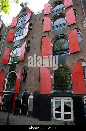 Building with red shutters in Amsterdam Stock Photo