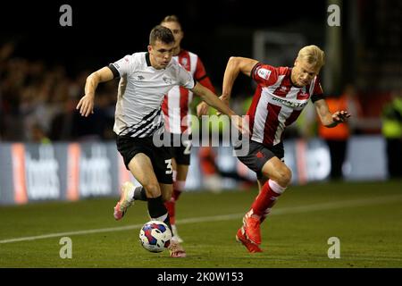 Derby County’s Jason Knight (left) and Lincoln City’s Lasse Sorensen in action during the Sky Bet League One match at the LNER Stadium, Lincoln. Picture date: Tuesday September 13, 2022. Stock Photo