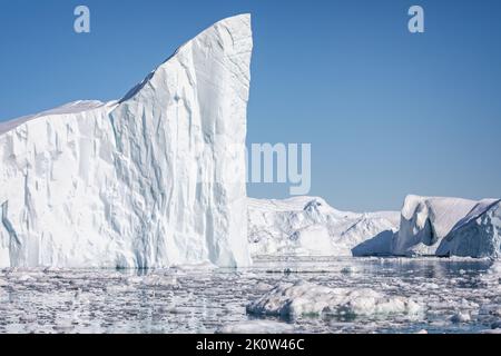 Towering great icebergs in the Ilulissat Icefjord in Greenland Stock Photo