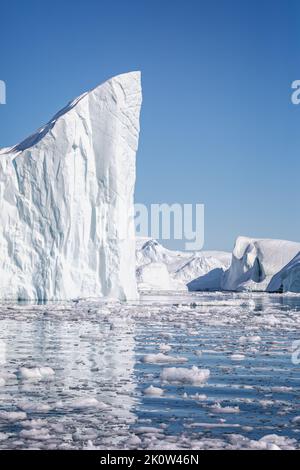 Towering great icebergs in the Ilulissat Icefjord in Greenland Stock Photo