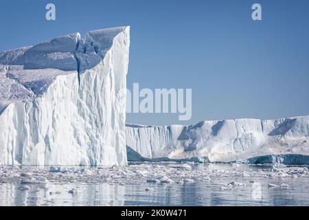 Towering great icebergs in the Ilulissat Icefjord in Greenland Stock Photo