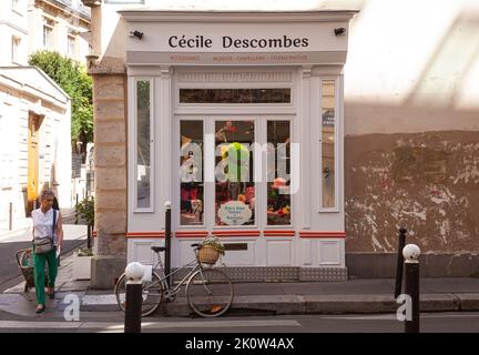 Paris, France - July, 15: Window of the accessories shop Cécile Descombes in the typical french street with shops on the first floor in house. Vintage Stock Photo