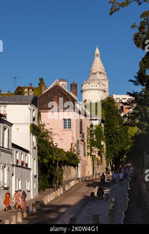 Paris, France - July, 15: View of the Montmartre quarter with the Pink House restaurant called La Maison Rose and the Basilica of Sacred Heart in fren Stock Photo