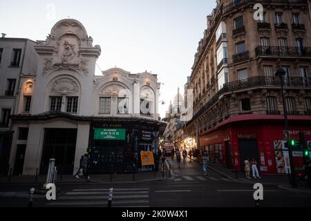 Paris, France - July, 15: Sunset view of the Elysee Montmartre theater, in French Élysée Montmartre with the Sacred Heart at background on July 15, 20 Stock Photo