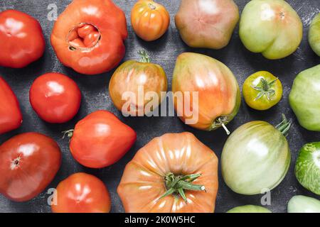 Variety of organic untreated multicolored tomatoes as a natural multicolored background Stock Photo