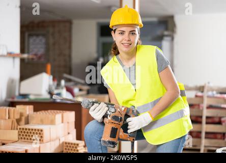 Female builder posing on indoor construction site Stock Photo