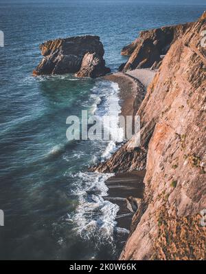 A vertical view of the Trefor sea stacks on the Llyn peninsula and crystal clear sea Stock Photo