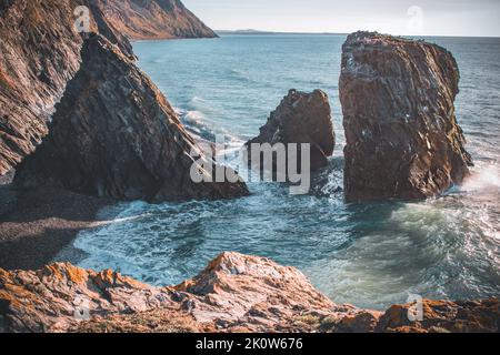 A scenic view of the Trefor sea stacks on the Llyn peninsula and crystal clear sea Stock Photo