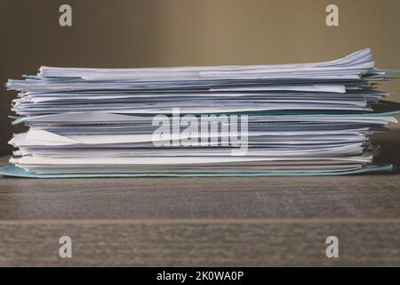 Stack of Documents isolated on a wooden desk. Concept of business, work and education. Copy space Stock Photo