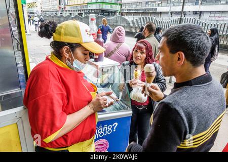 Bogota Colombia,San Victorino Carrera 10,ice cream parlor shop,counter woman women female employee worker working customer customers ordering,Colombia Stock Photo