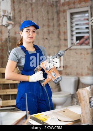 Female worker posing on indoor construction site Stock Photo